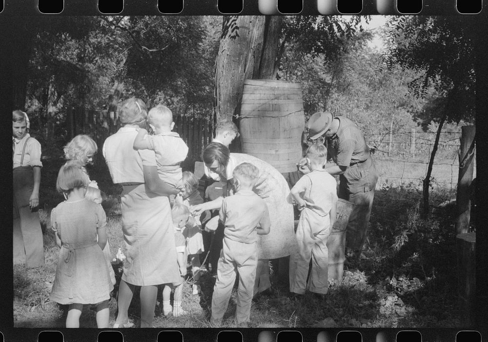 [Untitled photo, possibly related to: Parishoners gossiping while waiting for picnic supper at St. Thomas Church Picnic near…