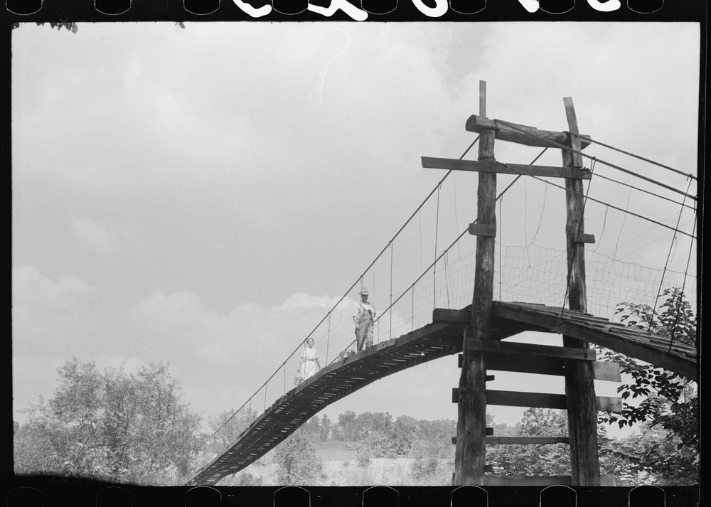 Mountaineers crossing the Kentucky River over swinging bridge, carrying their supplies home from Jackson. Breathitt County…