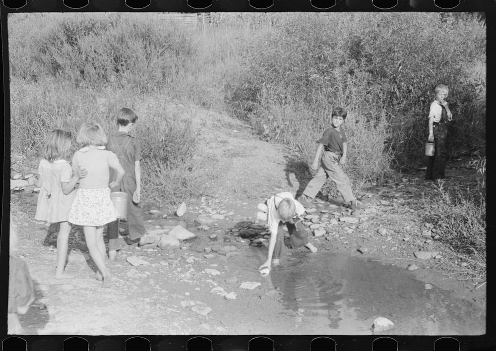 [Untitled photo, possibly related to: Children going home from school up Frozen Creek carrying their lunch pails. School is…