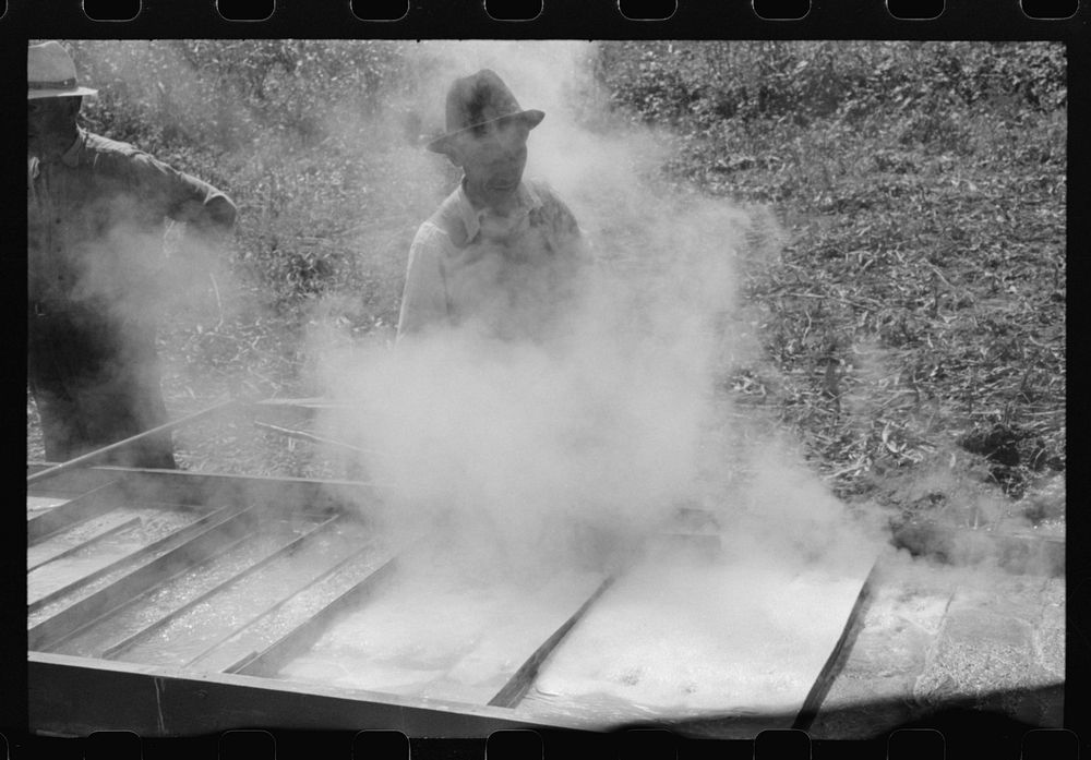 [Untitled photo, possibly related to: Boiling down the sorghum cane sap into syrup. At a mountaineer's home on the highway…