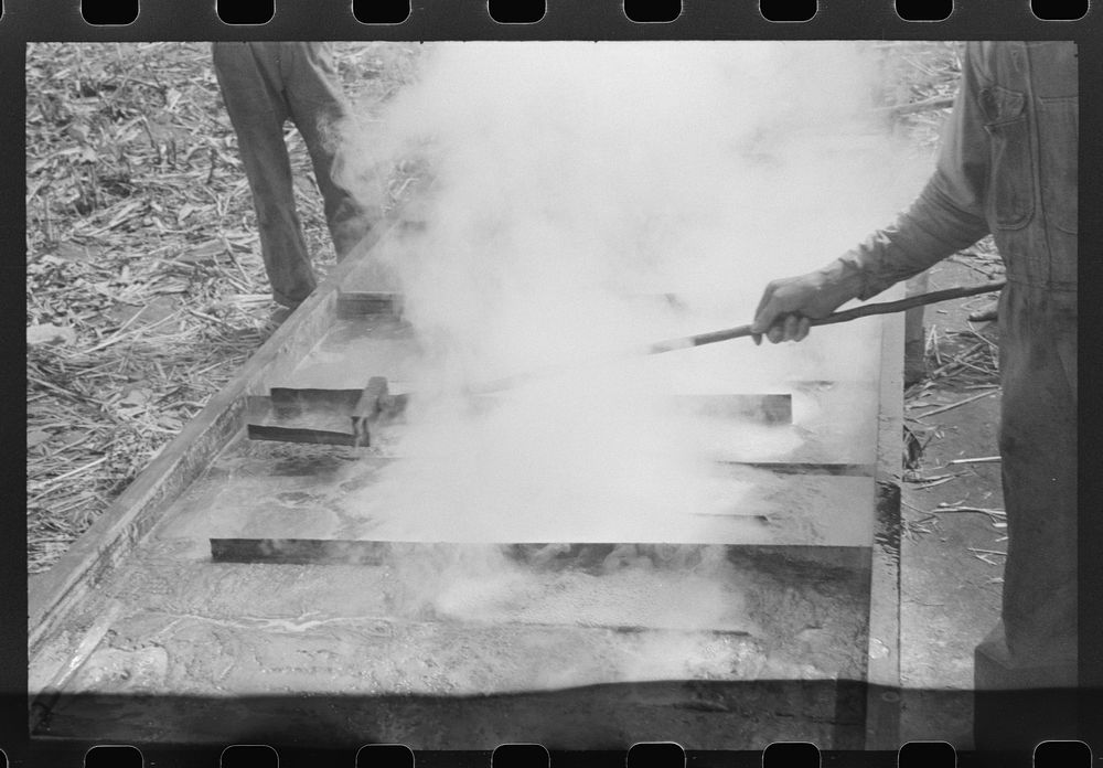 Boiling down the sorghum cane sap into syrup. At a mountaineer's home on the road between Jackson and Campton, Kentucky.…