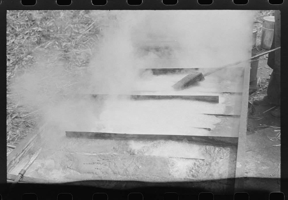 [Untitled photo, possibly related to: Boiling down the sorghum cane sap into syrup. At a mountaineer's home on the road…