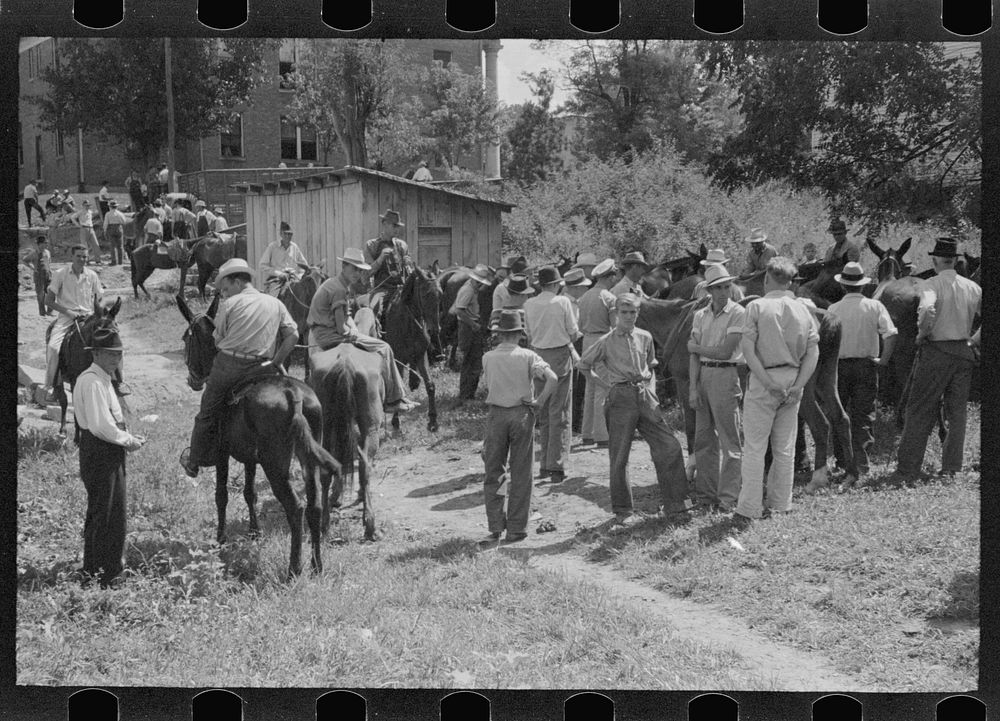 [Untitled photo, possibly related to: Farmers trading mules and horses on "Jockey Street" in Campton, Kentucky]. Sourced…