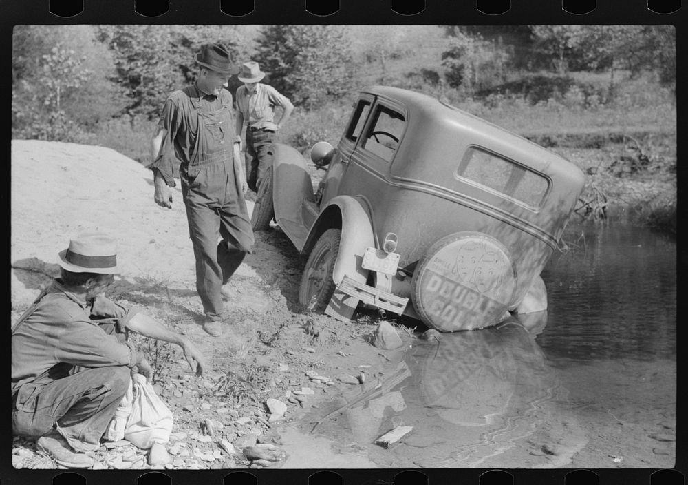 Mountaineers trying to get car out of creek. Up South fork of the Kentucky River, Breathitt County, Kentucky by Marion Post…