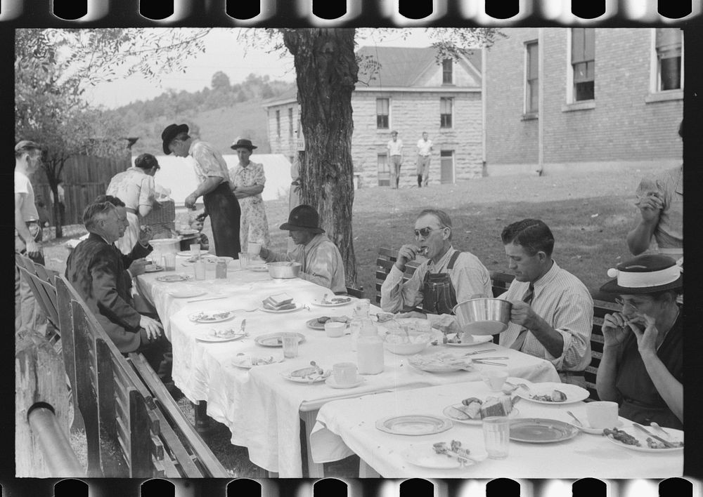 Mountaineers and farmers eating dinner served for benefit of the church in courthouse yard on court day. Campton, Wolfe…