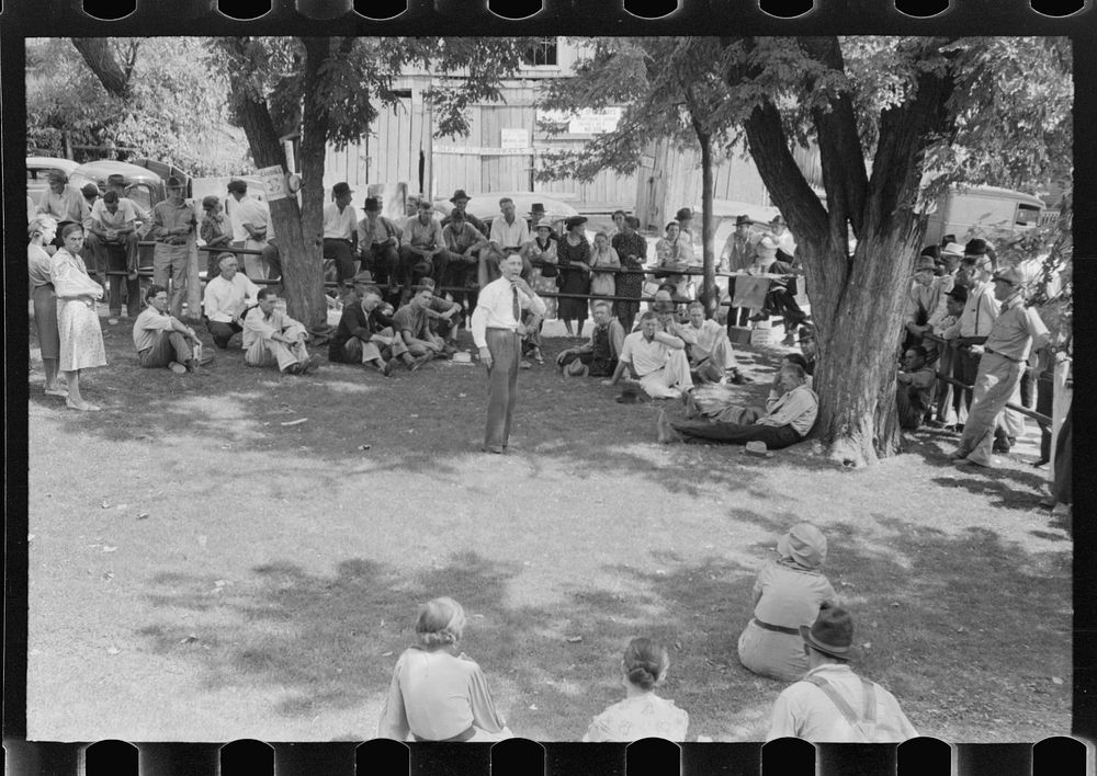 [Untitled photo, possibly related to: Community people listening to itinerant preacher in courtyard on court day, Campton…