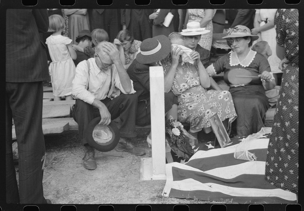 Mother and relatives weeping at the grave of the deceased at memorial meeting near Jackson, Kentucky, Breathitt County. See…