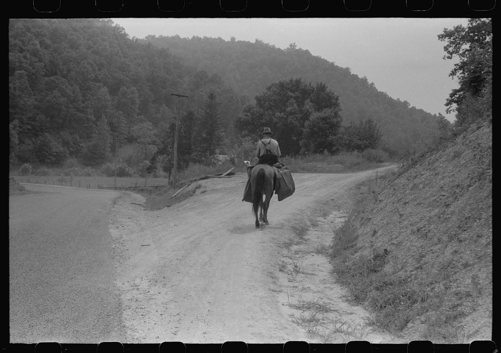 Rural postman who delivers mail to the mountain families up the side roads and creek beds. Near Jackson, Kentucky. Sourced…