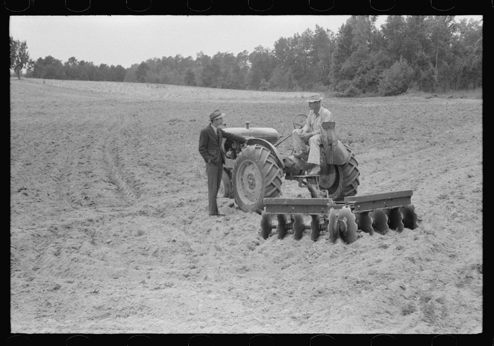Connie B. Gay, FSA (Farm Security Administration) county supervisor talking to Emery Hooper about his tractor and disc plow…