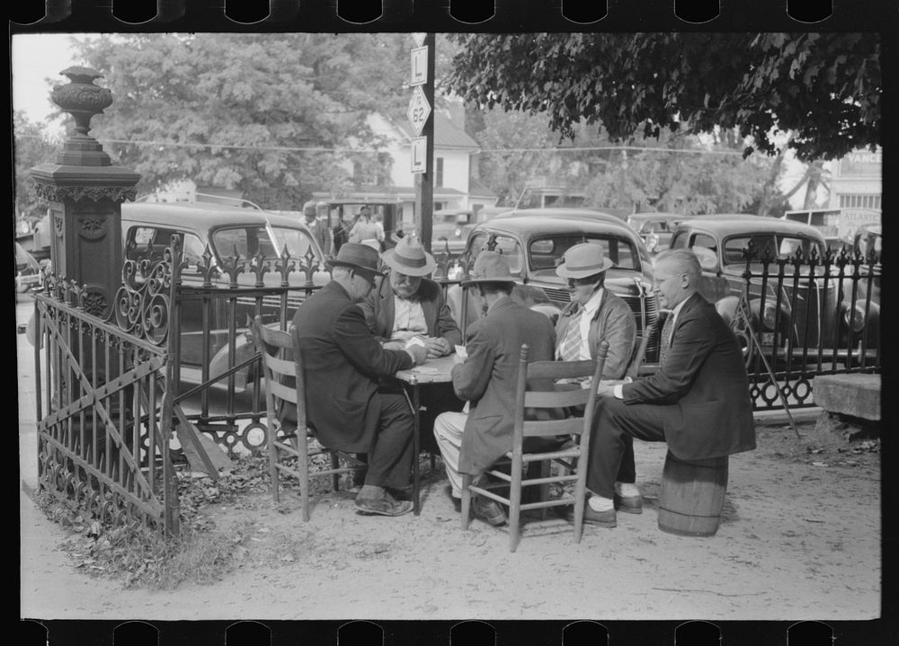 Members of the community playing cards in front of the courthouse, Yanceyville, Caswell County, North Carolina. Sourced from…