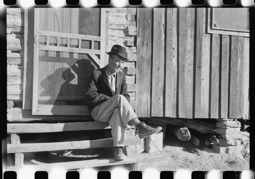 [Untitled photo, possibly related to: Noah Garland sitting on the steps of his son's home, Southern Appalachian Project…