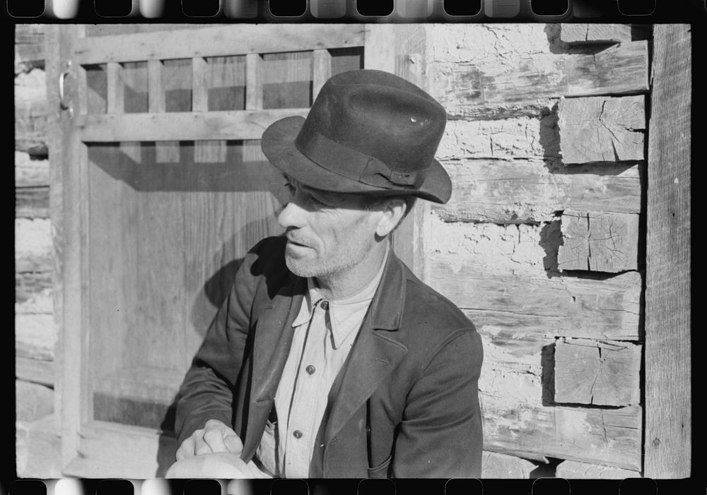 [Untitled photo, possibly related to: Noah Garland sitting on the steps of his son's home, Southern Appalachian Project…