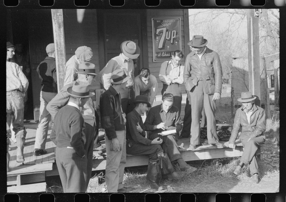 Spanish trappers and fur buyers crowd around FSA (Farm Security Administration) supervisor as he opens and reads the bids on…
