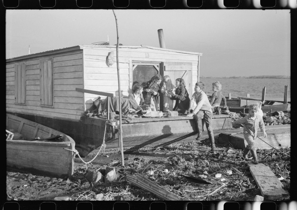 Spanish trappers' children playing in front of their camp in the marshes near Delacroix Island, Louisiana. See general…