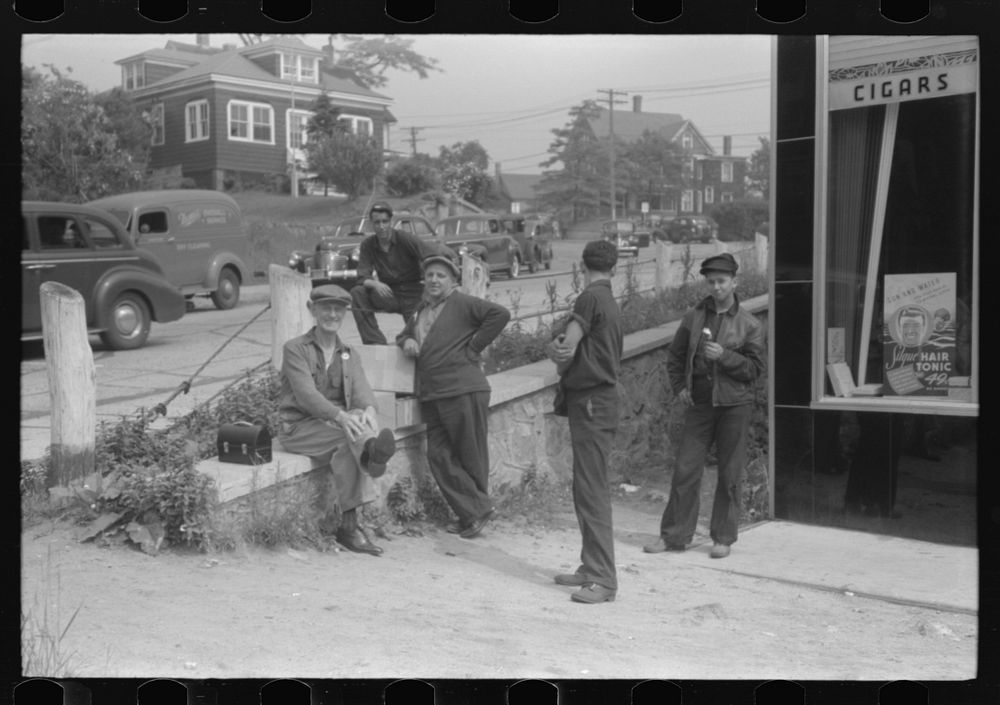 Workers lounging around town and waiting for a lift home at afternoon change of shift of Electric Boat Works, Groton…