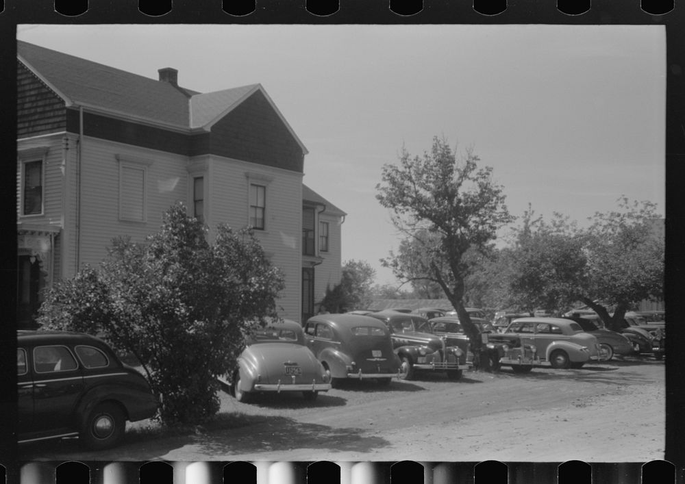 Cars parked in yard of private home across from Pratt and Whitney, United Aircraft. They charge fifty cents a week or ten…