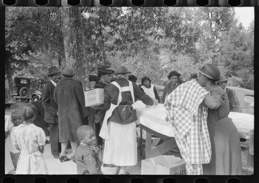 Cleaning up and visiting after outdoor picnic at an all-day ministers and deacons meeting. Near Yanceyville, Caswell County…
