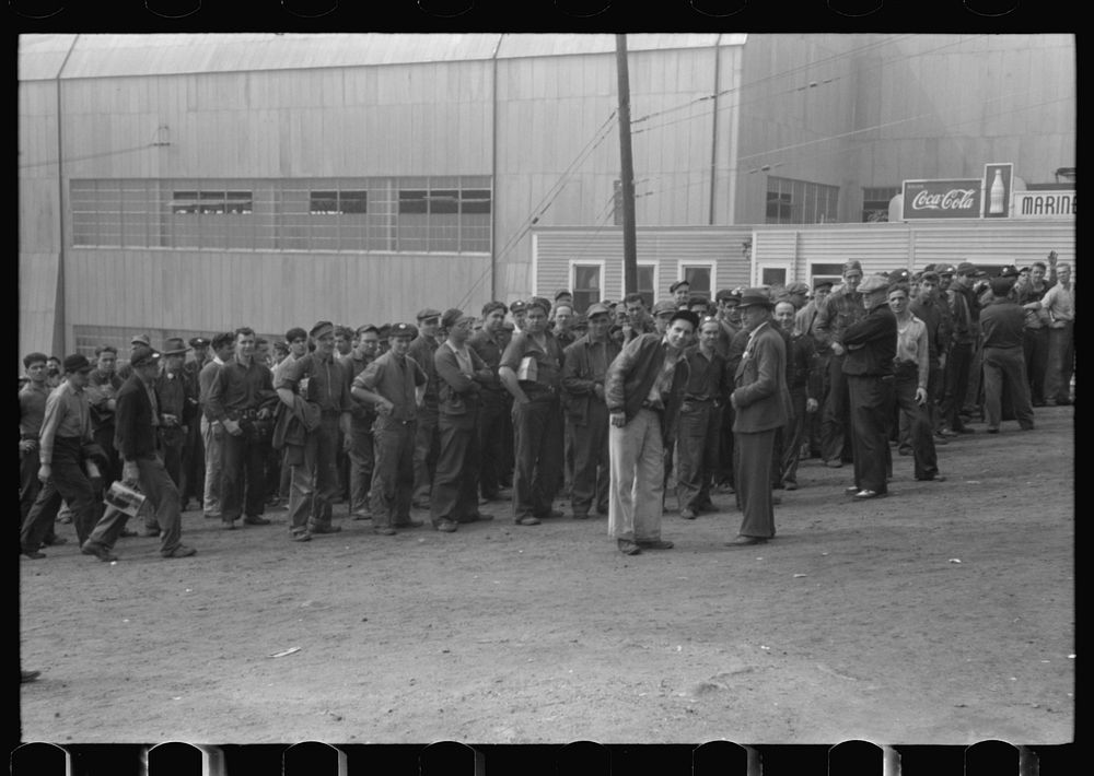 [Untitled photo, possibly related to: Workers leaving plant at change of shift before being paid off. Electric Boat Works…
