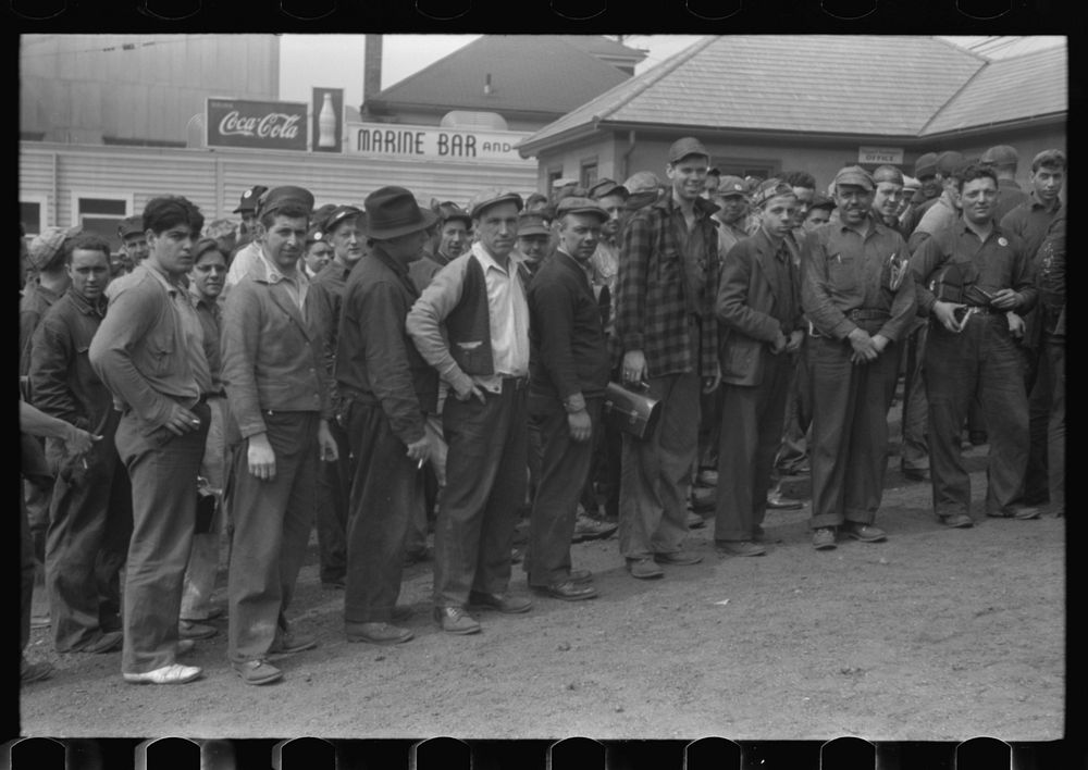 Workers leaving plant at change of shift before being paid off. Electric Boat Works, Groton, Connecticut. Sourced from the…