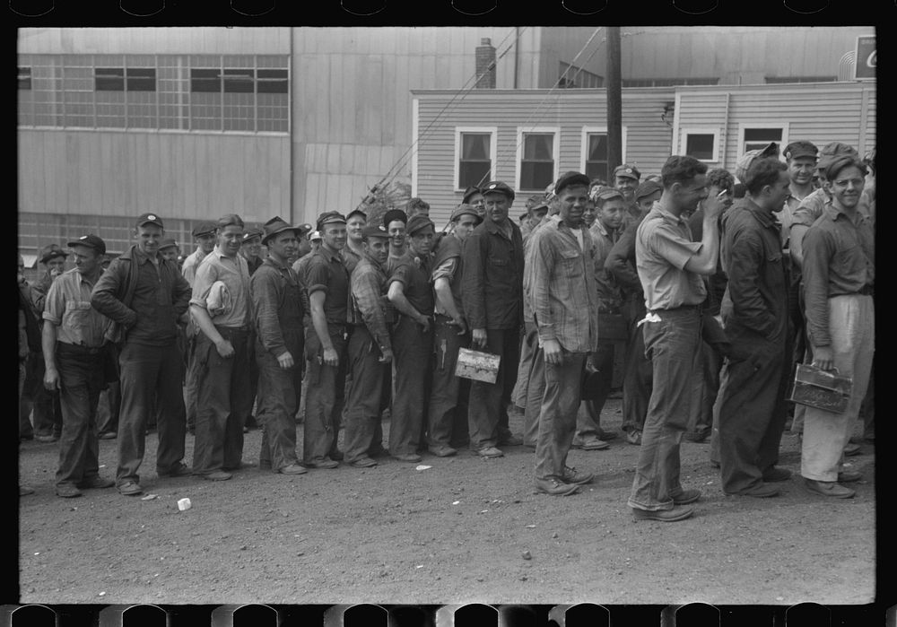 Workers leaving plant at change of shift before being paid off. Electric Boat Works, Groton, Connecticut. Sourced from the…