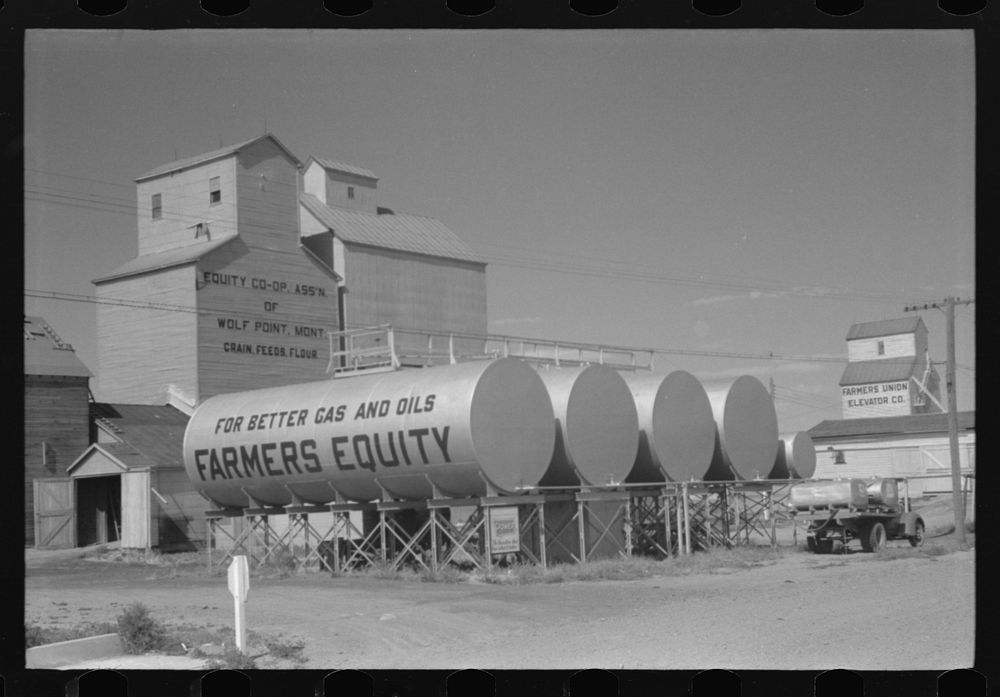 [Untitled photo, possibly related to: Farmers Equity Coop. Grain elevators and oil tanks, Wolf Point, Montana]. Sourced from…