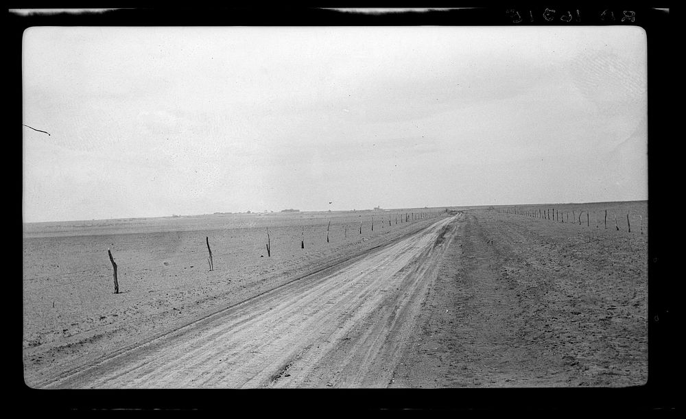Typical view of the rolling character of the area. Town of Mills in distance, New Mexico by Dorothea Lange
