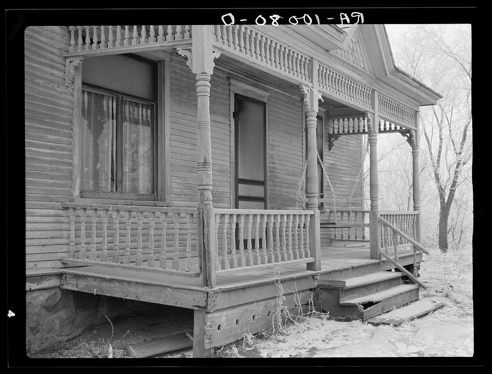 Front porch of house on Elmer Nelson farm. This farm has been in hands of loan company for at least fifteen years. Buildings…