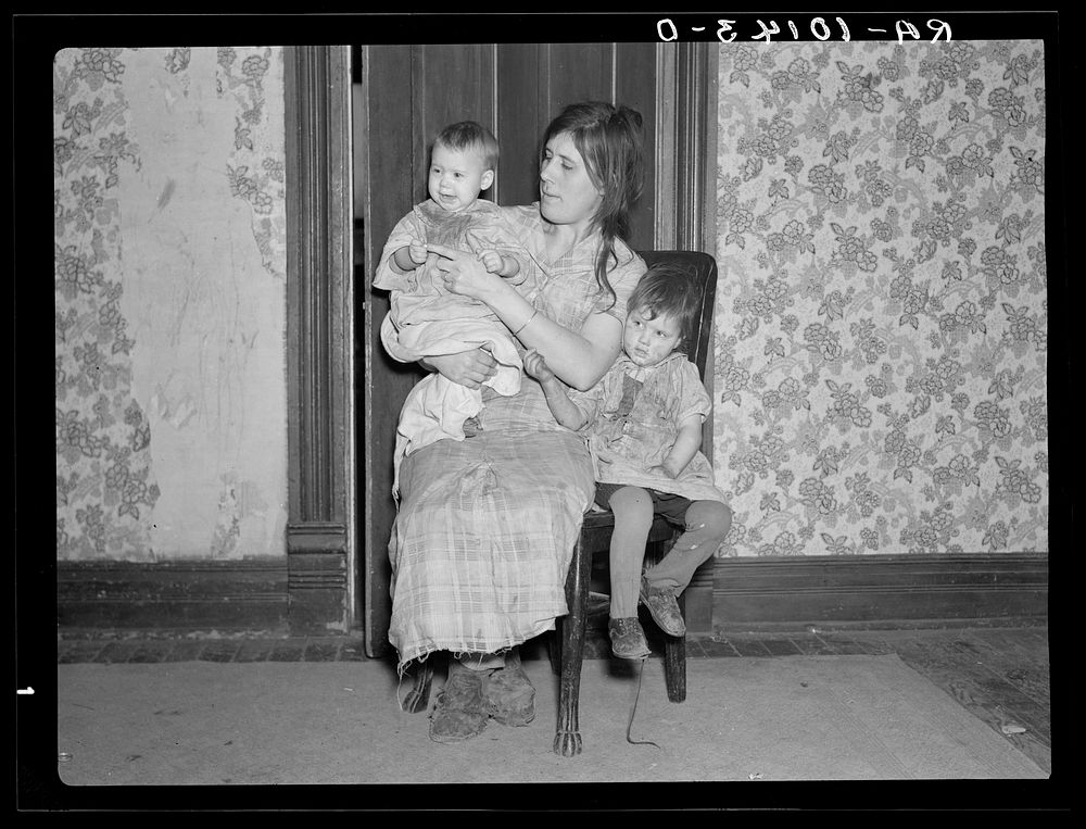 Mrs. Alfred Atkinson with baby and young child in farm home near Shannon City, Iowa. They rent eighty acres from an estate…
