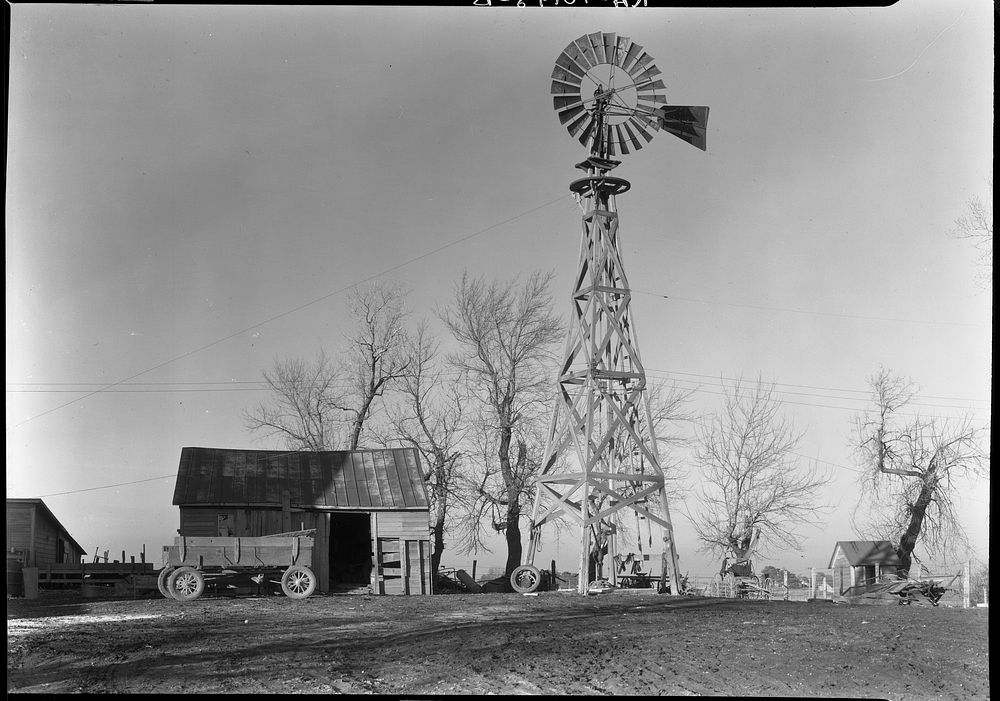 Old-style wooden windmill in farmyard of Martin Myre's farm near Seneca, Illinois by Russell Lee