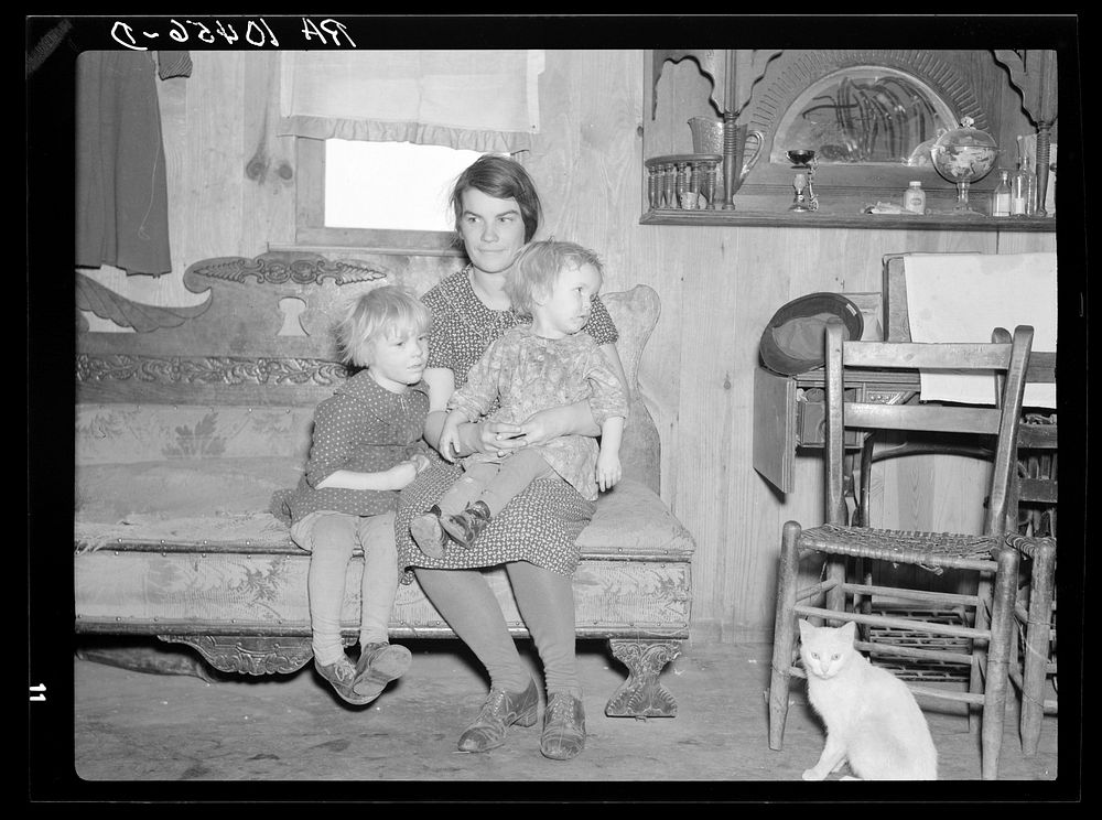 Mrs. Oscar Gaither and two of her five children in their farmhouse near McLeansboro, Illinois. Gaither is a tenant farmer of…