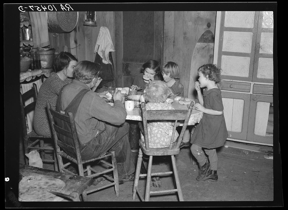 Oscar Gaither and family eating dinner. He is a tenant farmer near McLeansboro, Illinois by Russell Lee