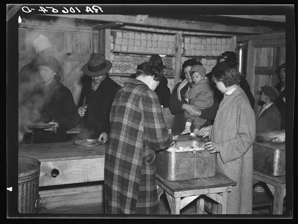 Flood refugees being fed at Tent City, near Shawneetown, Illinois. The people serving food are volunteers from among the…