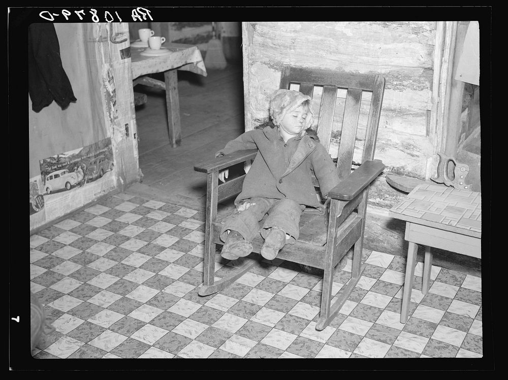 One of Mrs. Bodray's children asleep in their home near Tipler, Wisconsin by Russell Lee