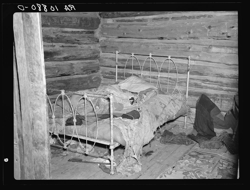 Bed in William Howell's home near Tipler, Wisconsin. He is a cut-over farmer with a family on relief by Russell Lee