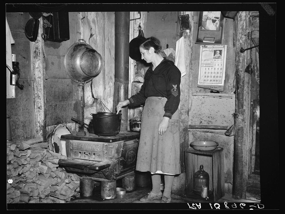 Mrs. Lon Allen stirring the soup in her home near Iron River, Michigan by Russell Lee