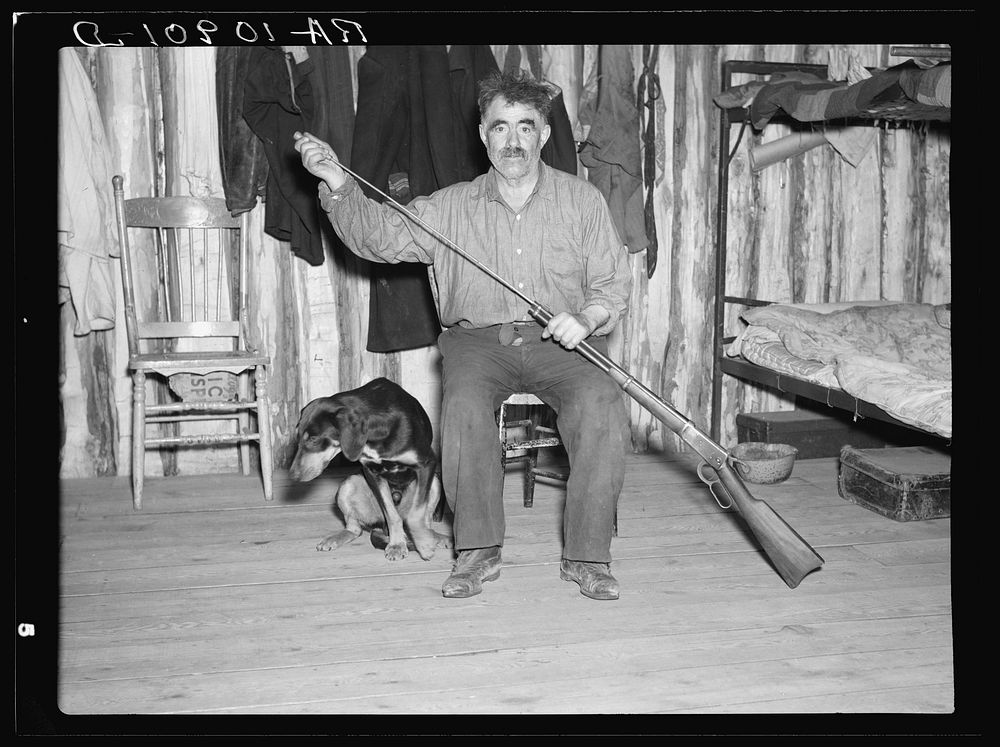 Black Aleck Dickinson and his dog Snoop. Iron County, Michigan by Russell Lee