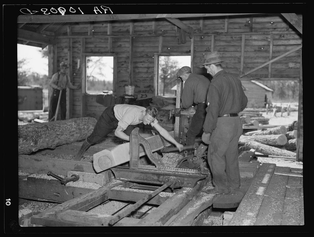 Sawing ties in a sawmill at Gibbs City, Michigan by Russell Lee