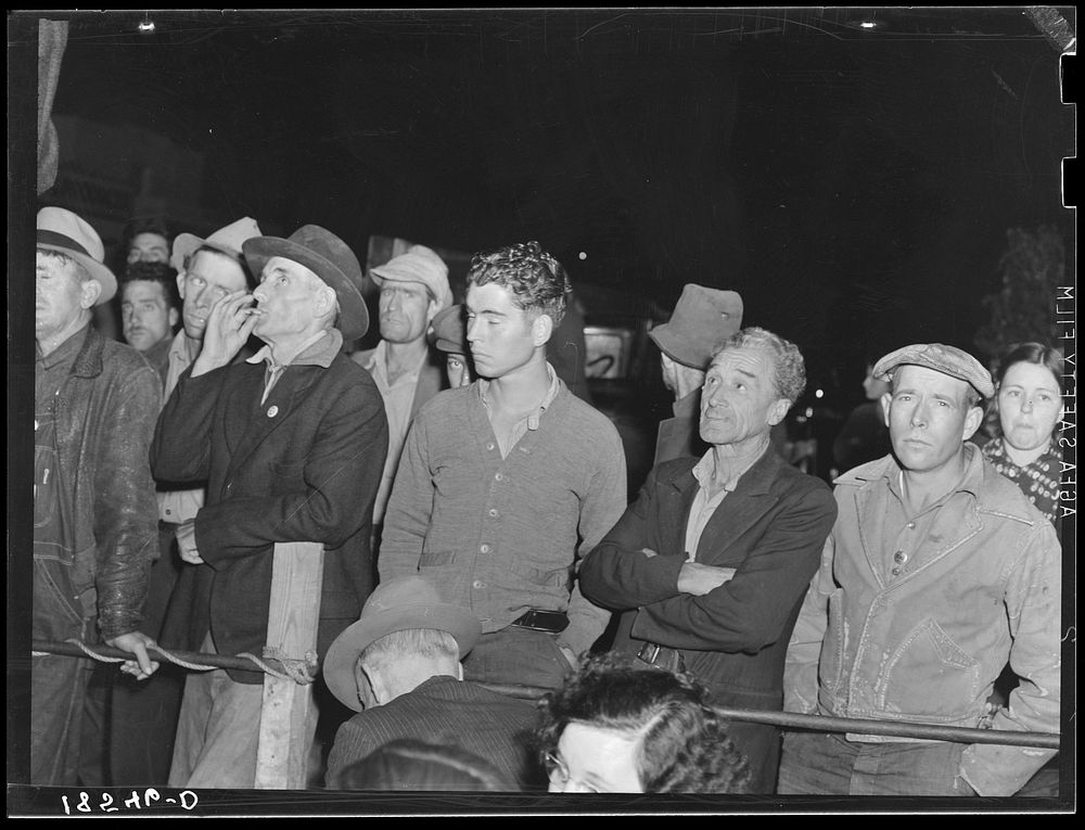 [Untitled photo, possibly related to: Street meeting at night in Mexican town outside of Shafter, California. Organizer for…