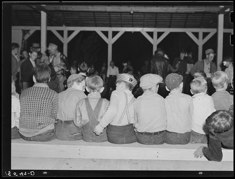 Young migrants waiting for signal to come for refreshments. Halloween party at Shafter camp for migrants, California.…