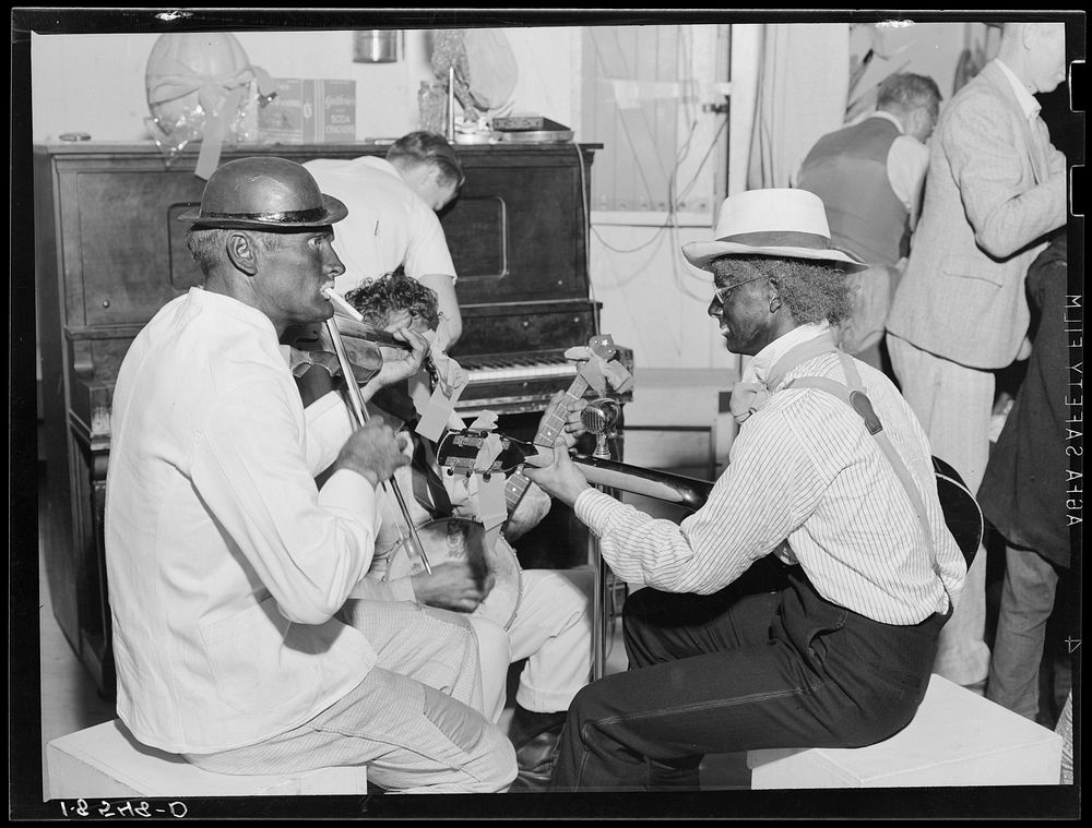 Camp talent provides music for dancing at Shafter camp for migrants. Halloween party, Shafter, California. Sourced from the…