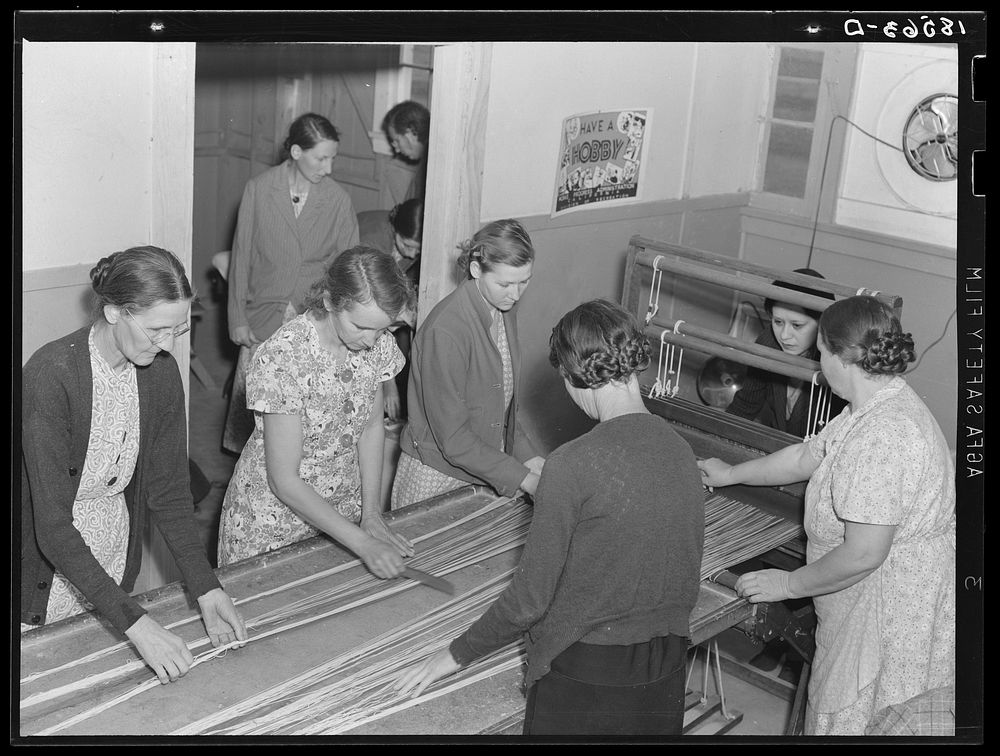 In the sewing room, migrant women are instructed in rug-making. Shafter camp for migrants (Farm Security Administration…