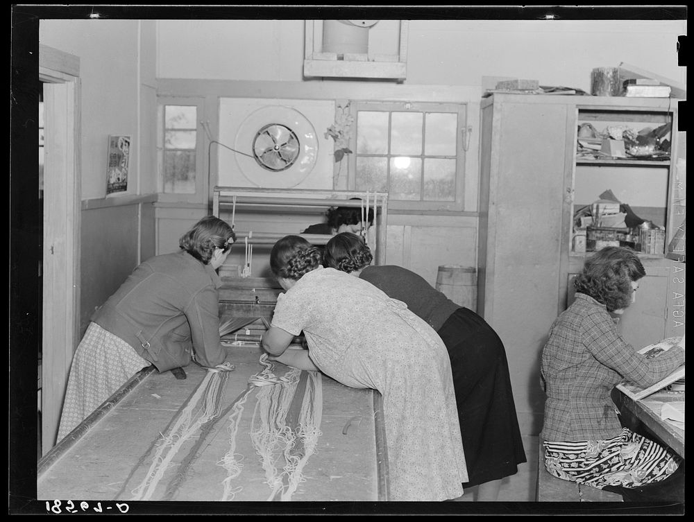 [Untitled photo, possibly related to: In the sewing room, migrant women are instructed in rug-making. Shafter camp for…