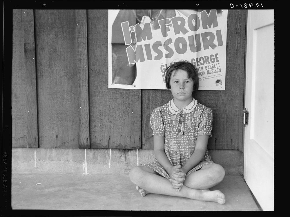 Advertisement for current movie in town. Westley, California. The child is a flood refugee of March 1939 from southeast…