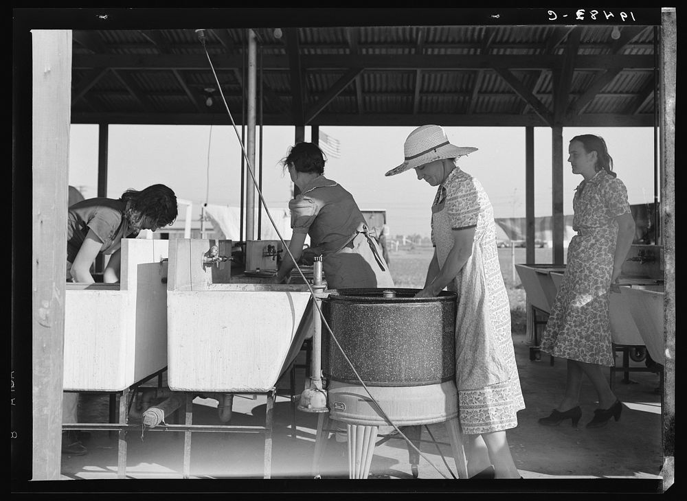 Laundry facilities in Farm Security Administration (FSA) migrant labor camp. Westley, California. Sourced from the Library…