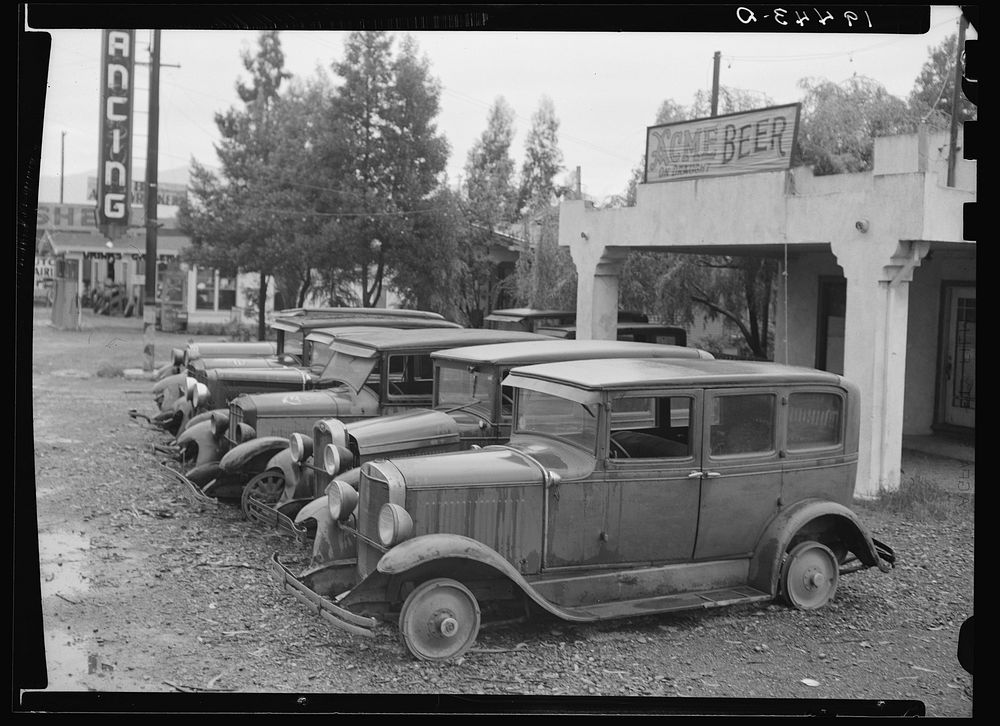Roadside used car display on State Highway 17, in season when migrants come into region for pea-picking. Santa Clara County…