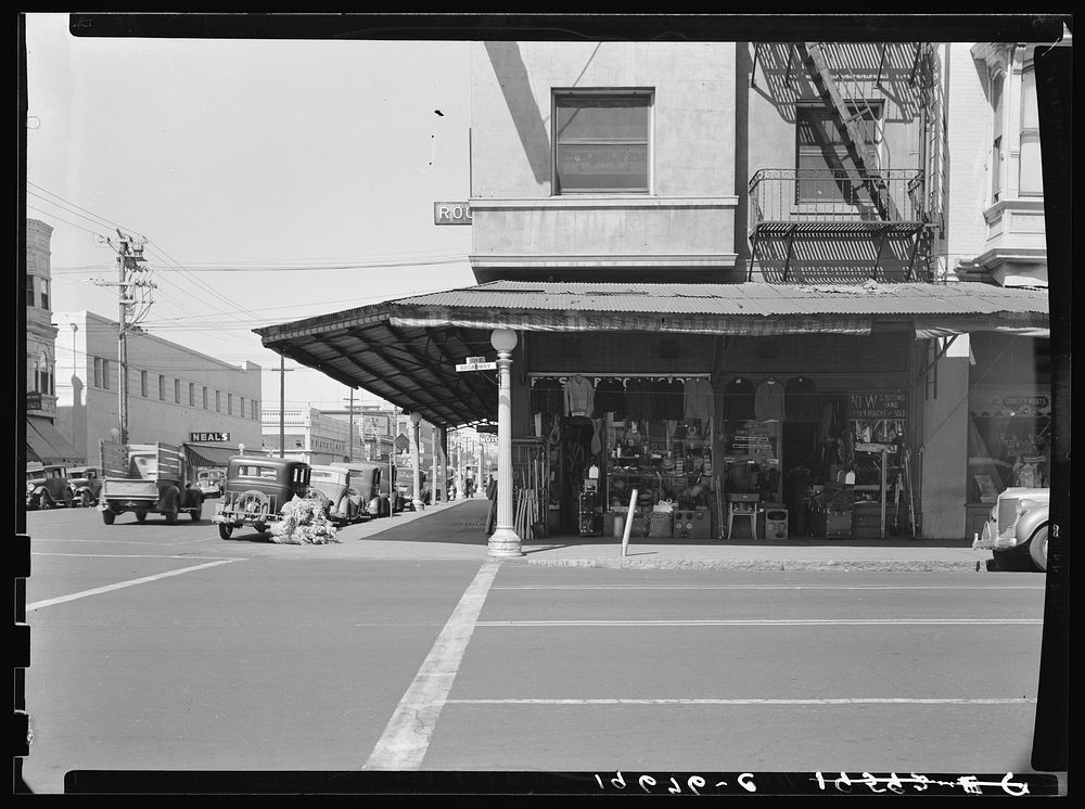 Fresno. Street corner of San Joaquin Valley town on U.S. 99 showing secondhand store. California. Sourced from the Library…