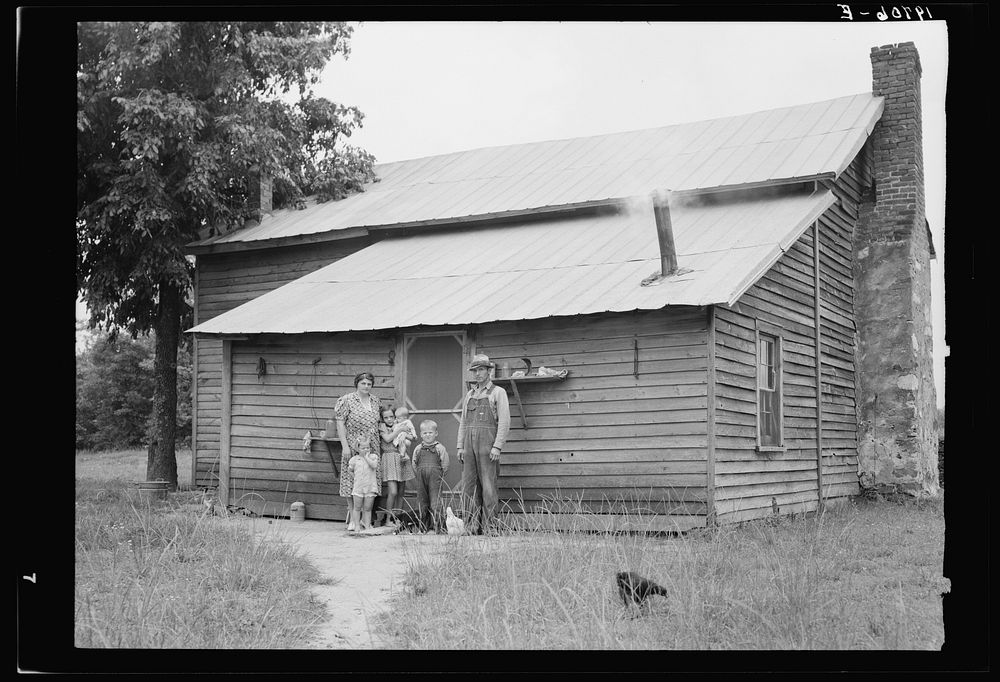 Tobacco sharecroppers and family at back of their house. Person County, North Carolina. Sourced from the Library of Congress.