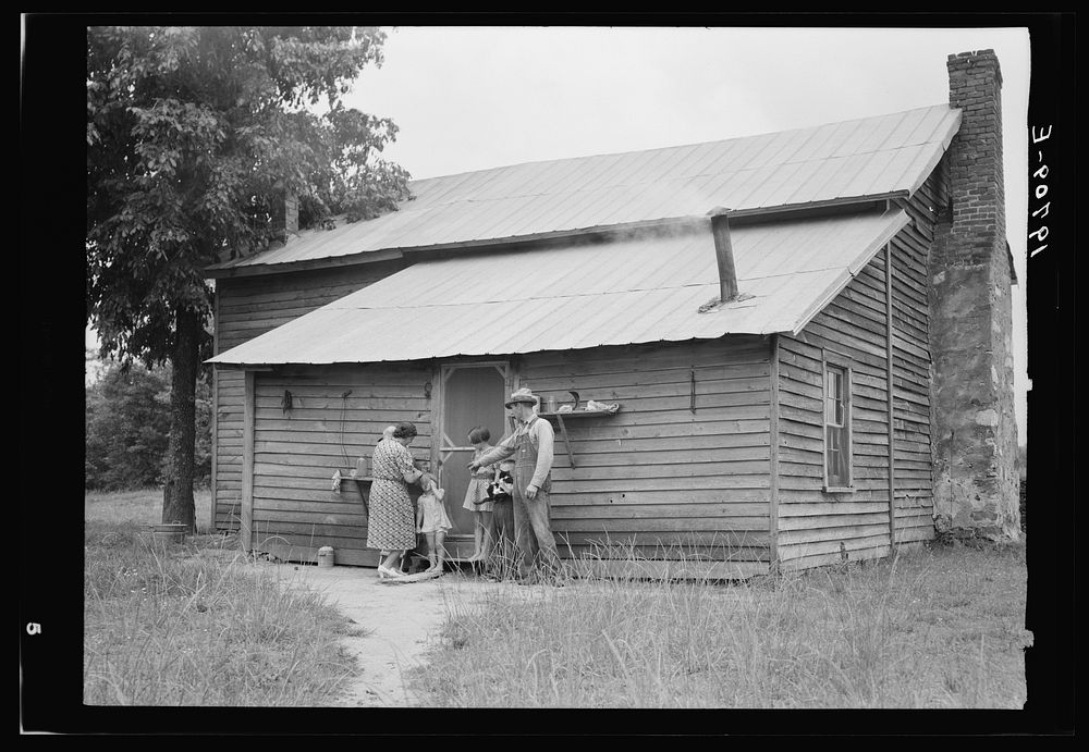 [Untitled photo, possibly related to: Tobacco sharecropper and his family at the back of their house showing kitchen door…