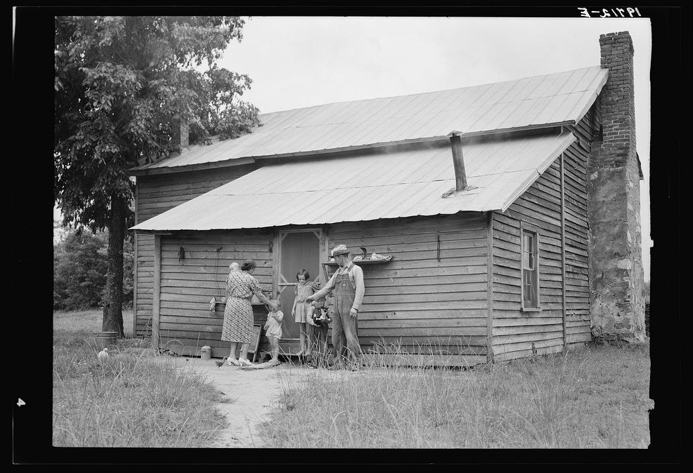 [Untitled photo, possibly related to: Tobacco sharecropper and his family at the back of their house showing kitchen door…