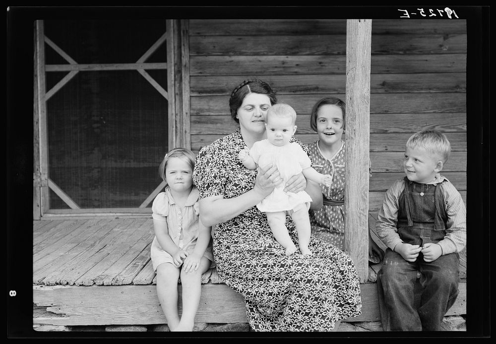 [Untitled photo, possibly related to: Wife and children of tobacco sharecropper on front porch. Person County, North…
